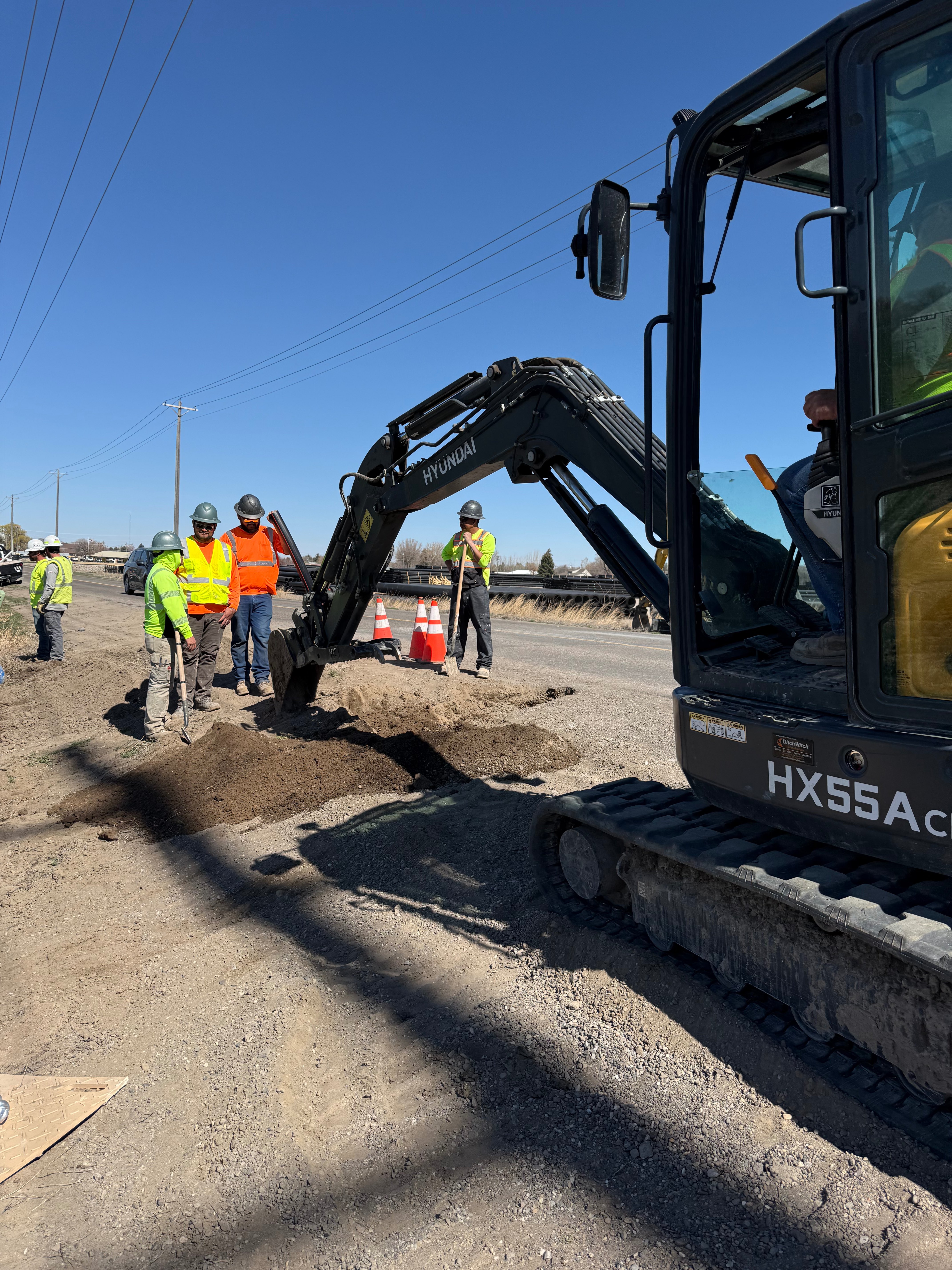 Western Mountain construction crew with Hyundai excavator at jobsite