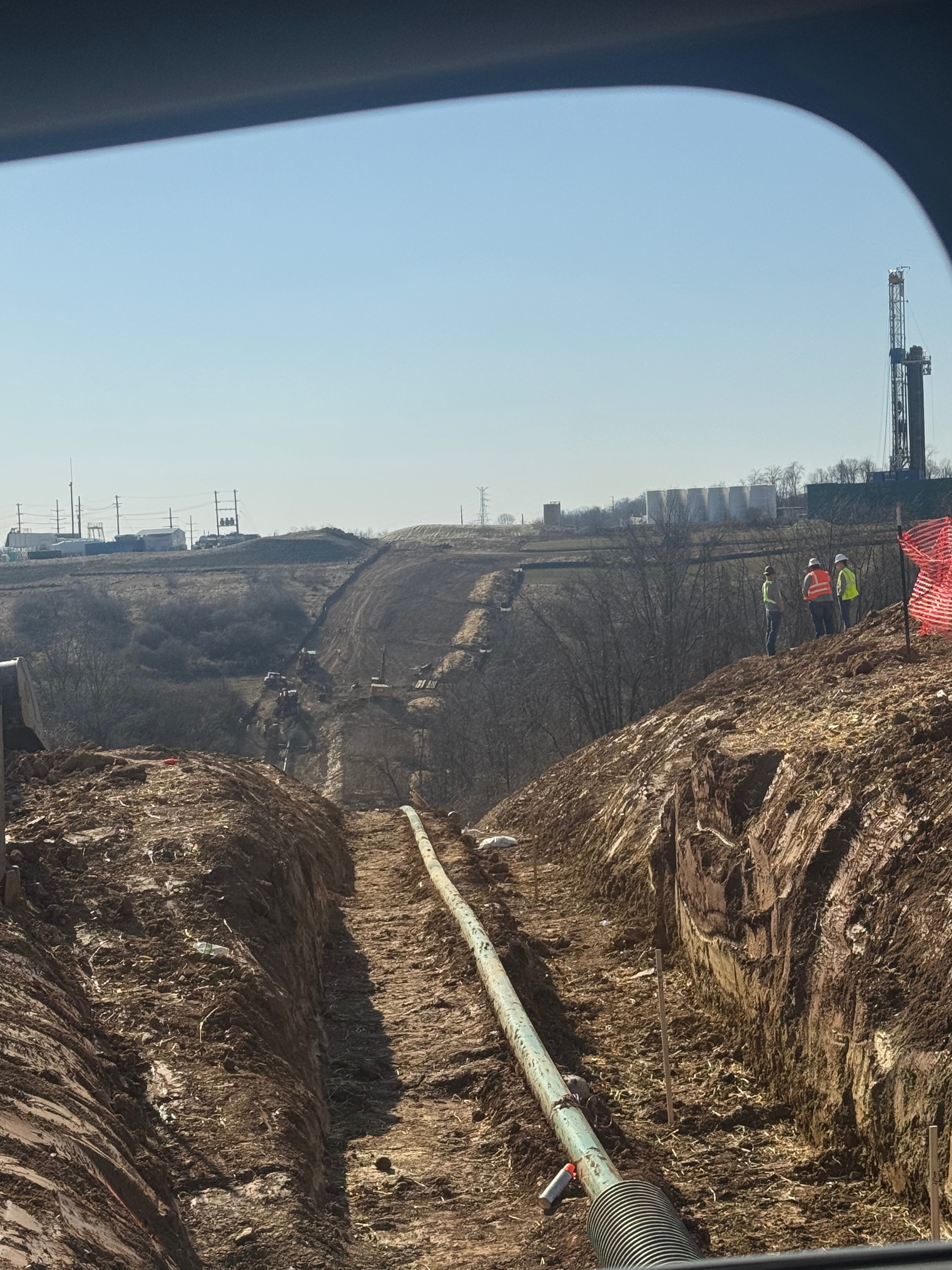 Large pipeline construction project with workers