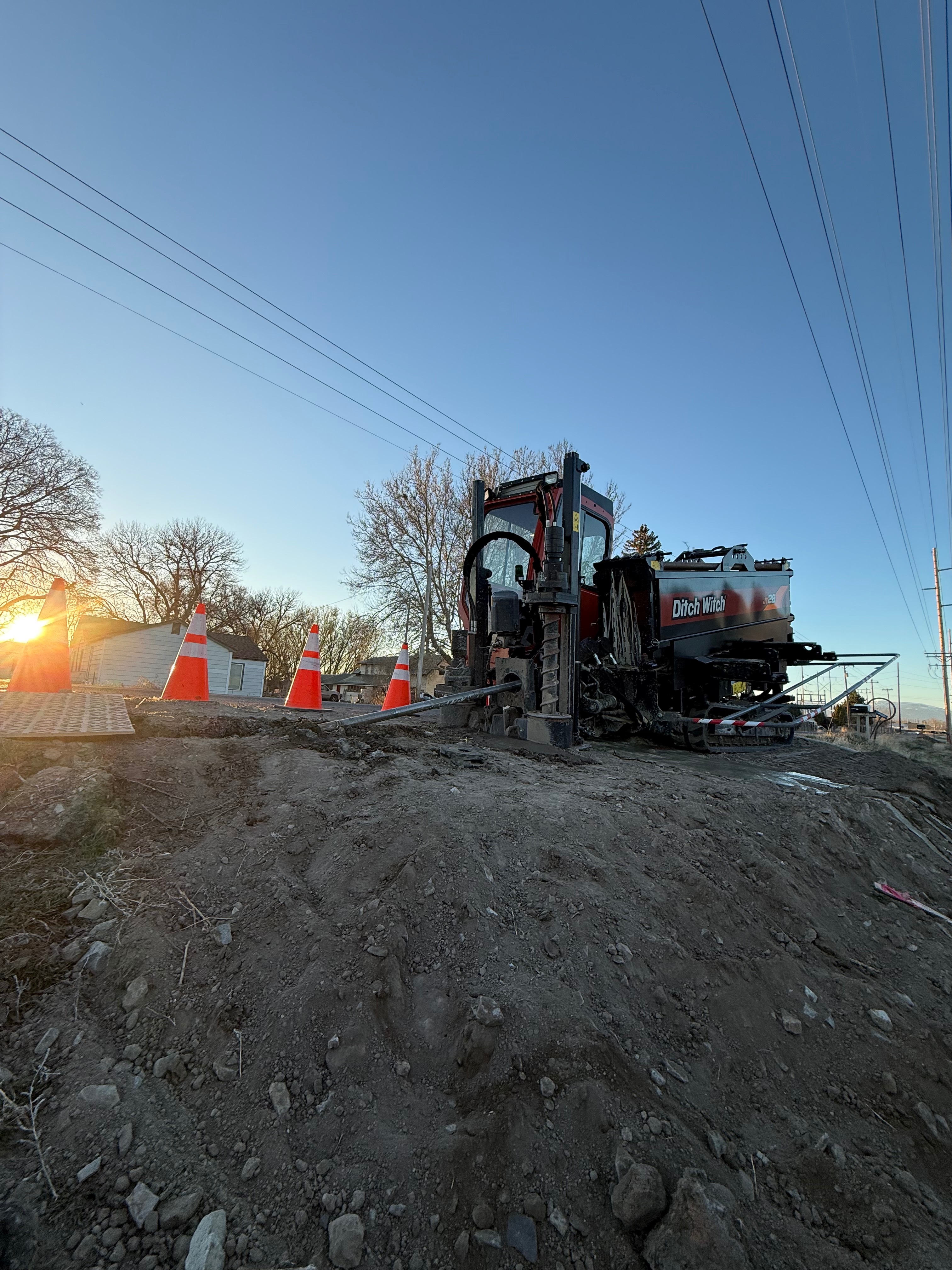 Ditch Witch directional drilling rig at sunset on residential street