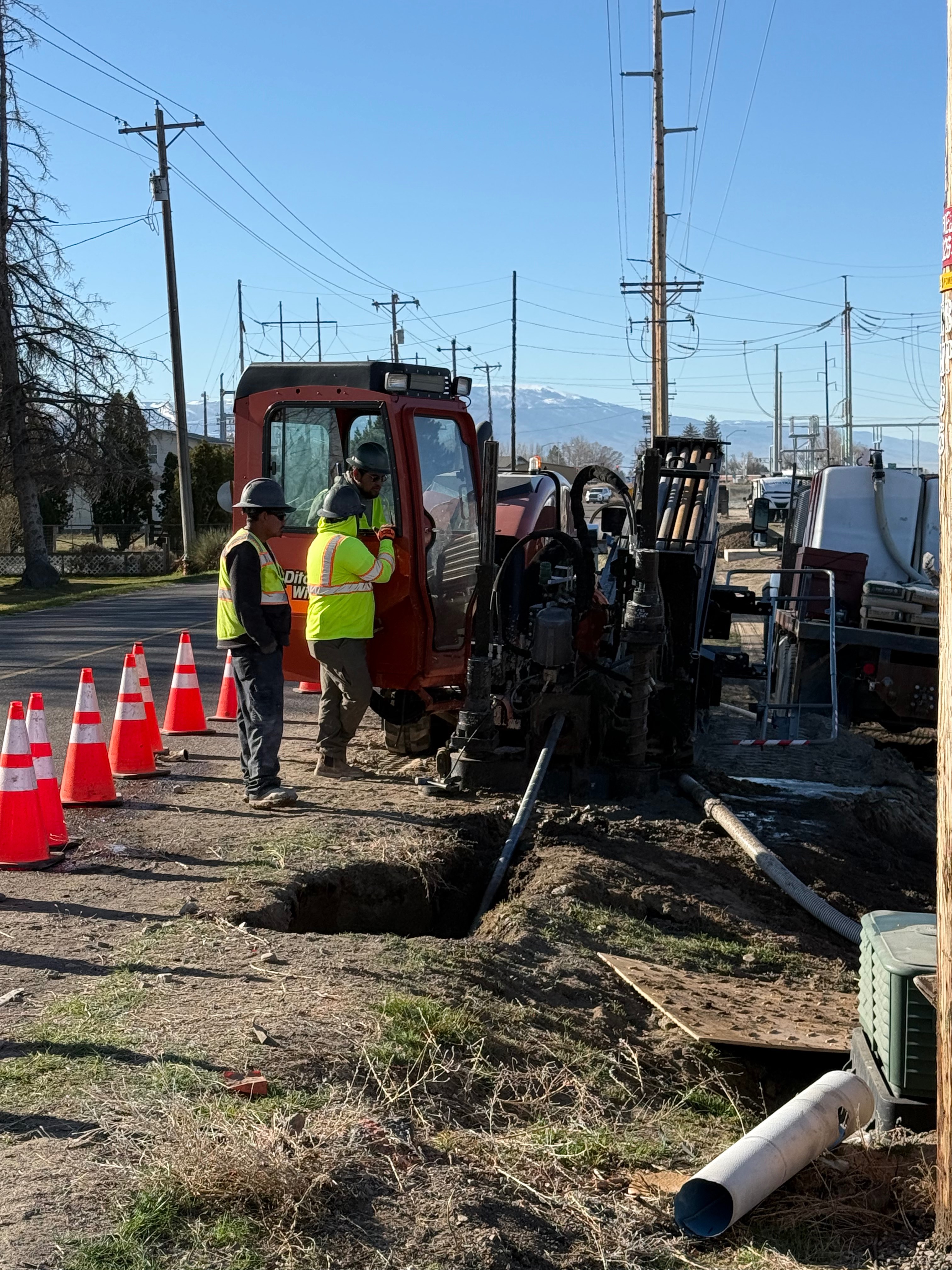 Ditch Witch directional drilling rig with crew on residential street